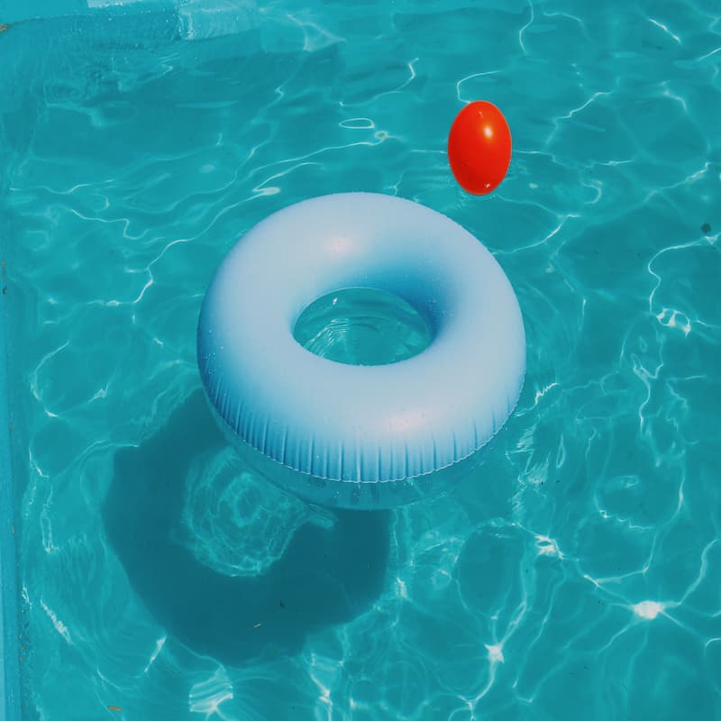 swimming pool floater and ball floating on water swimming pool floater and ball floating on water